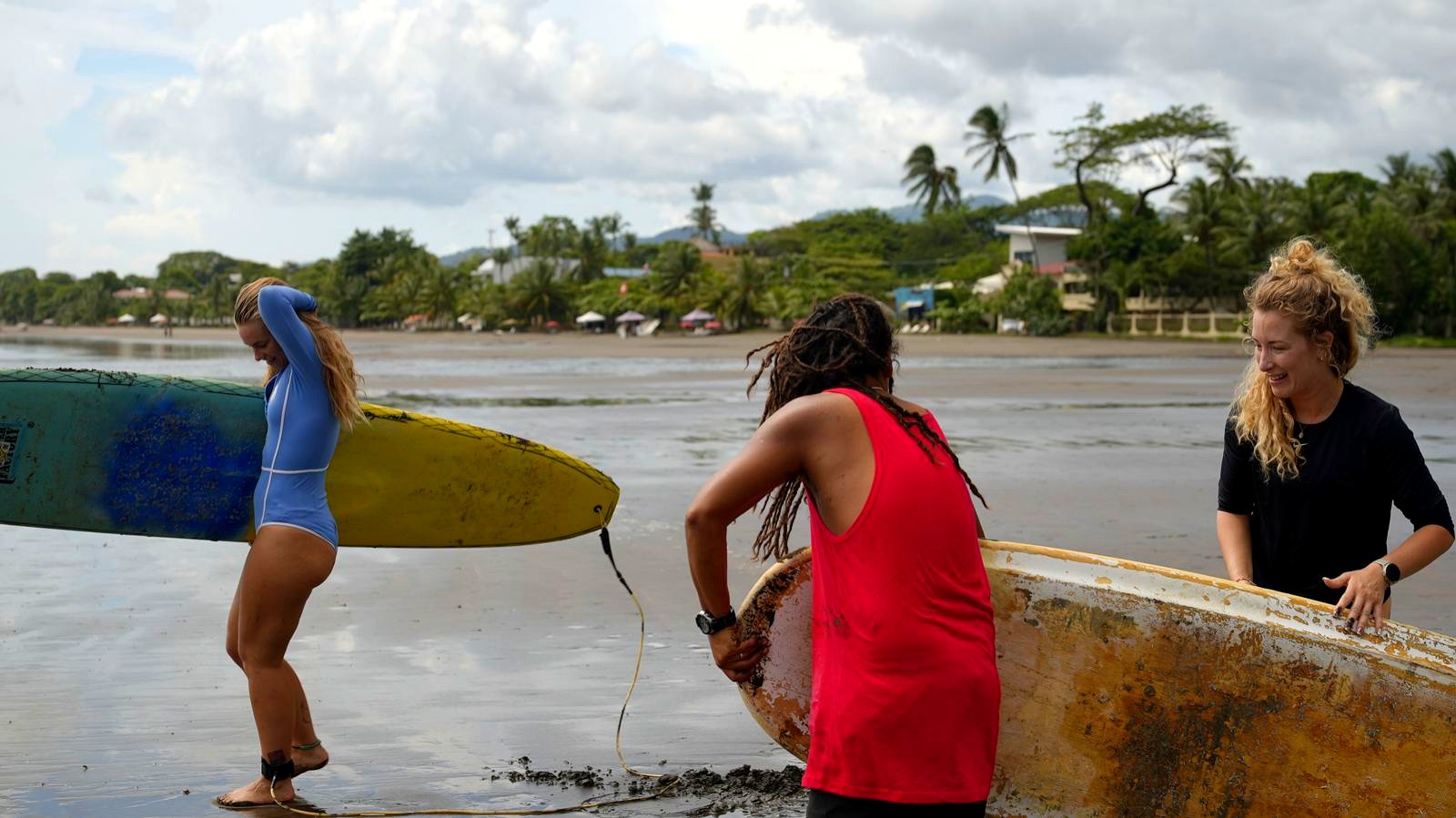 Surfers carrying boards
